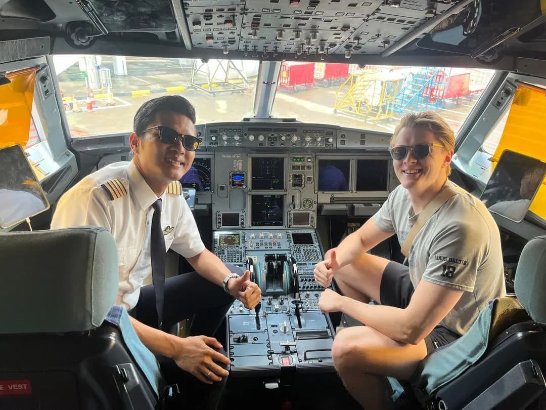 An associate sitting in the flight deck of a freighter beside a captain