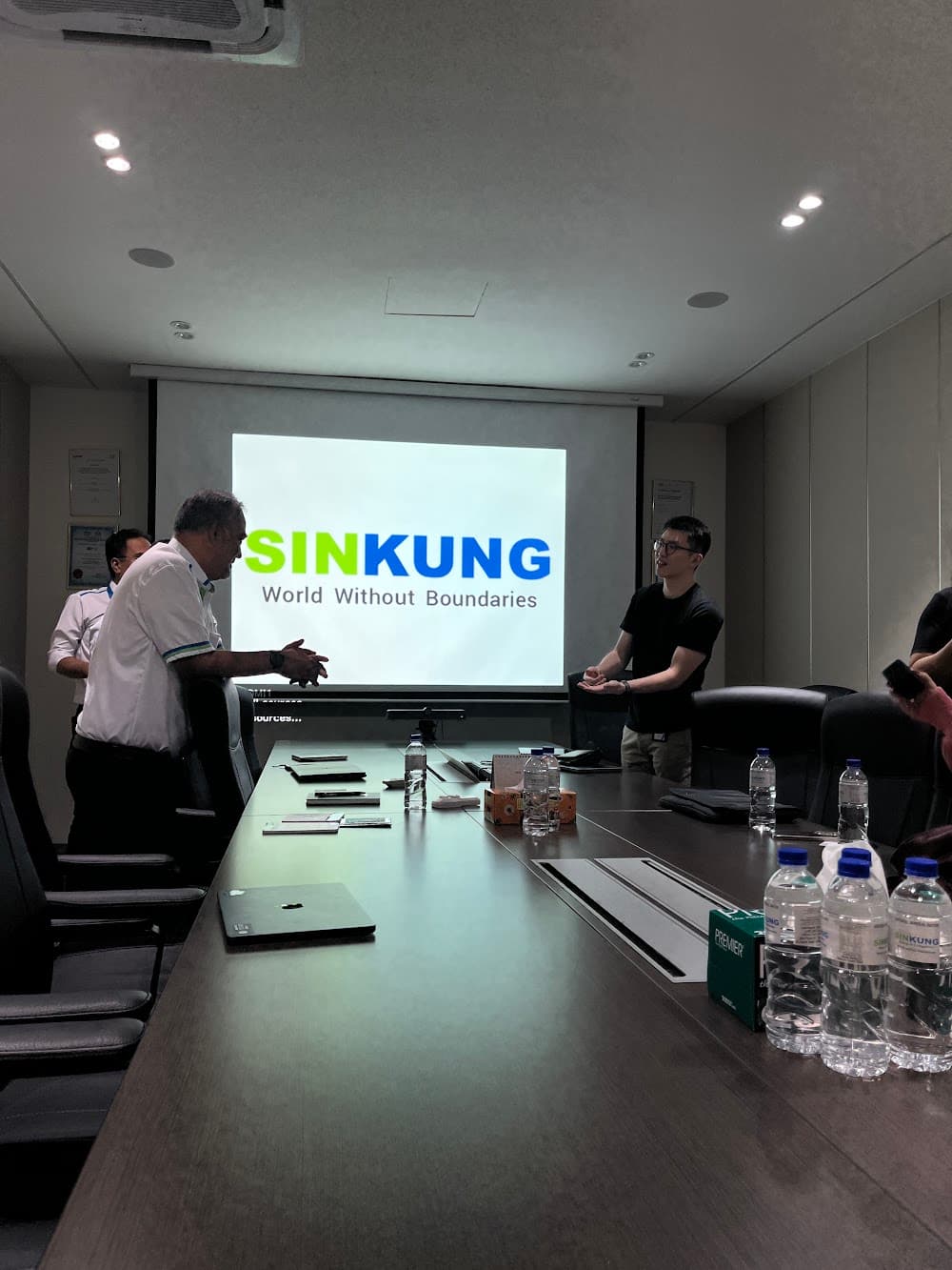Meeting with the Sin-Kung team in their boardroom, the Sin-Kung logo on the screen