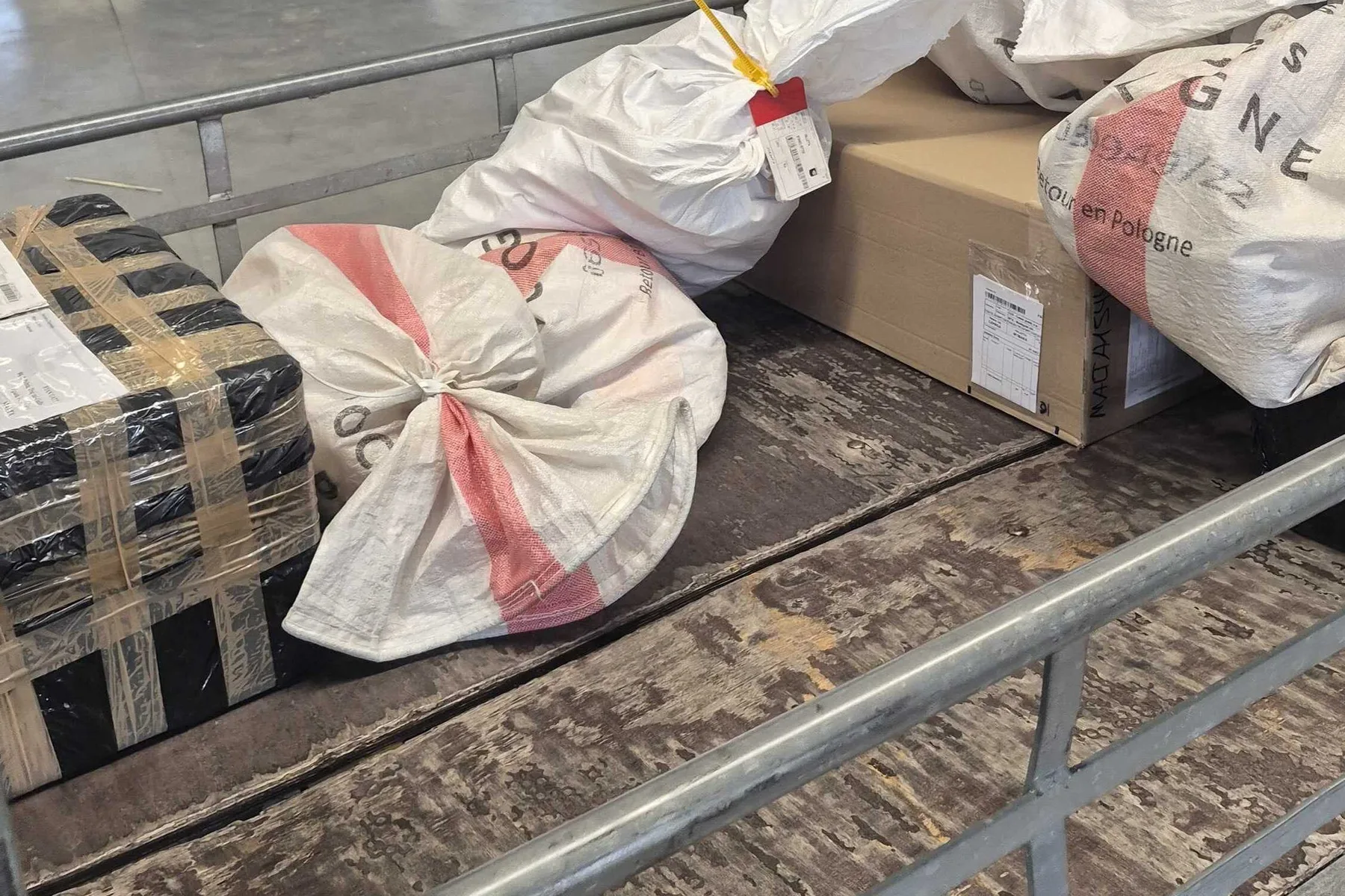 Mail sacks and parcels on a cargo trolley at the airBaltic Cargo hub